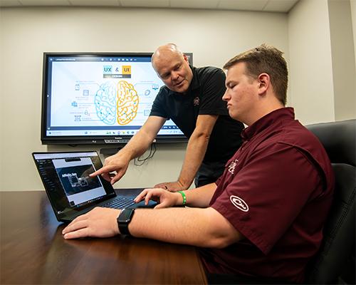 Greg Francom, associate professor of instructional design and LUX program coordinator, instructs Carter Peeples, an MSU senior ITS major from Brandon. MSU is launching a new bachelor’s degree this fall to prepare students for cutting-edge careers in learning and user experience design, one of the fastest growing career fields. (Photo by Bryce Mitchell)
