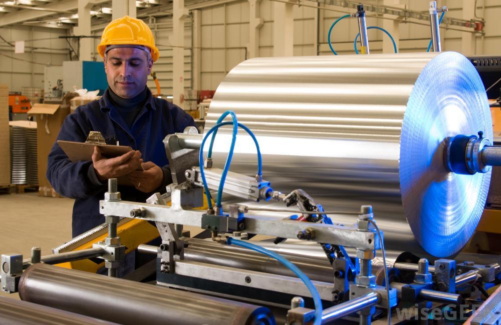 Man in hard hat inspects machine