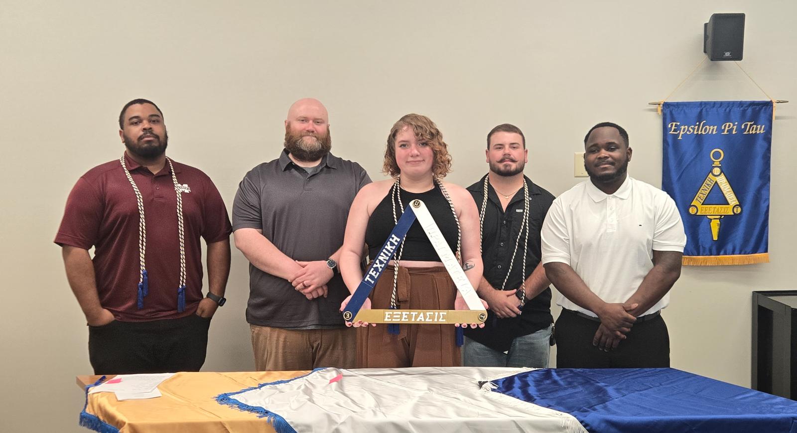 Five students pose for a photo during an honor society induction